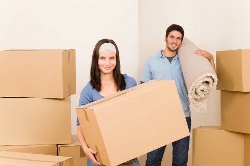 Loading furniture and boxes into a moving truck in Catford