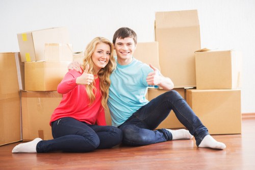 Local office relocation team handling furniture and boxes in Catford
