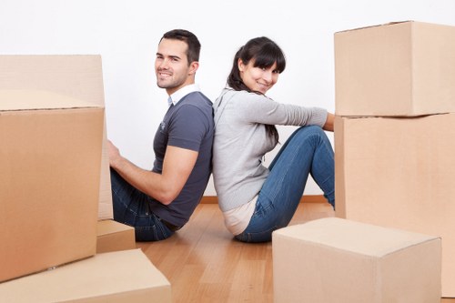 Workers handling a fragile item carefully during a removals job