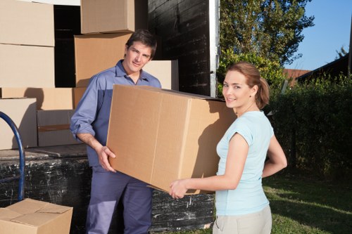 Moving crew handling furniture and boxes during a Catford move